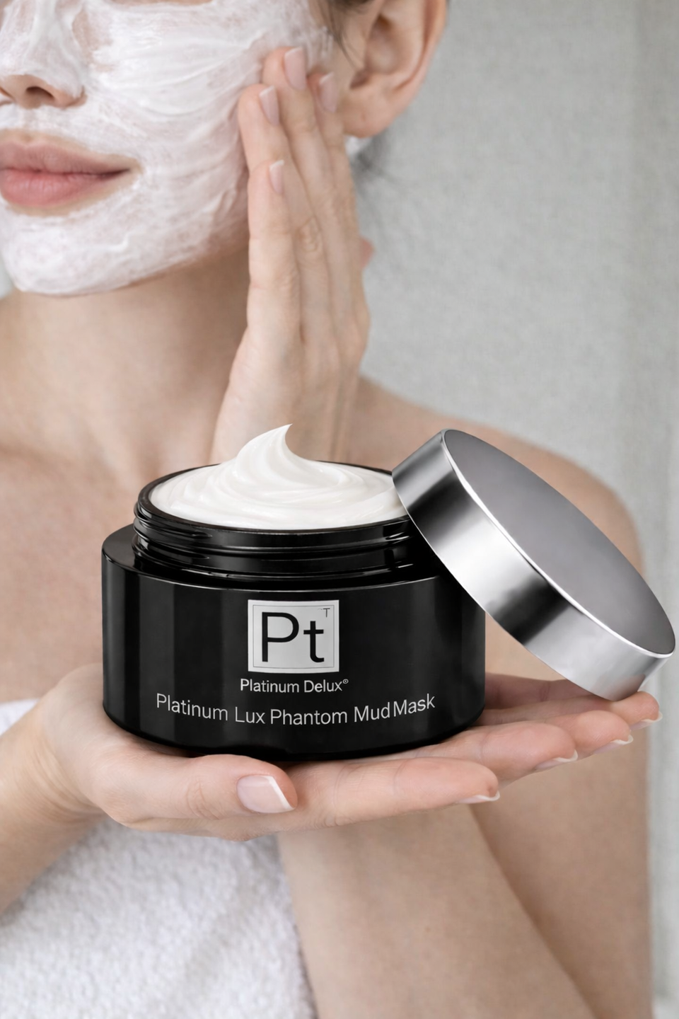 Woman applying Platinum Lux Phantom Mud Mask for deep cleansing and smoother looking skin
